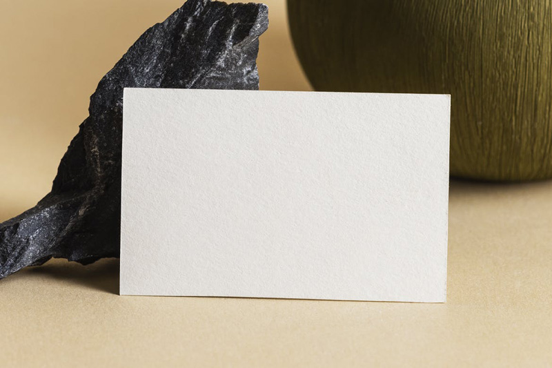 Blank business card on beige background mockup